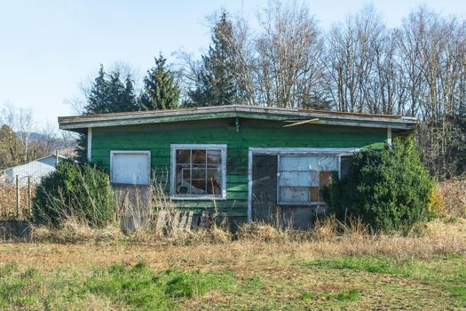 Old abandoned house in disrepair on cold fall day