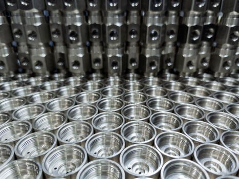 shiny steel industrial production parts after turning - close-up with selective focus