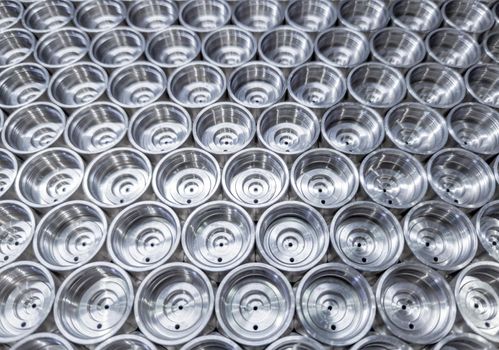 shiny steel industrial production parts after turning - close-up with selective focus