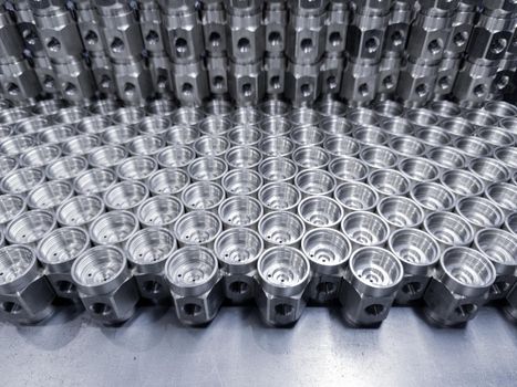 shiny machined metal parts - close-up industrial background with selective focus