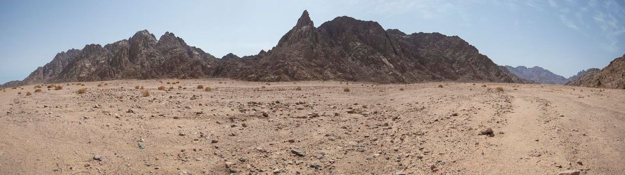Panoramic landscape scenic view of desolate barren eastern desert in Egypt with mountains