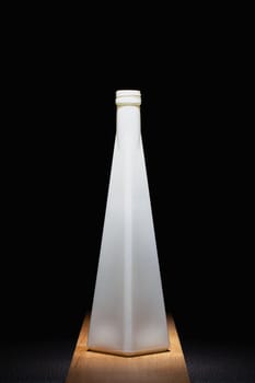 White empty vase on the wooden table in the dark room. Home decoration
