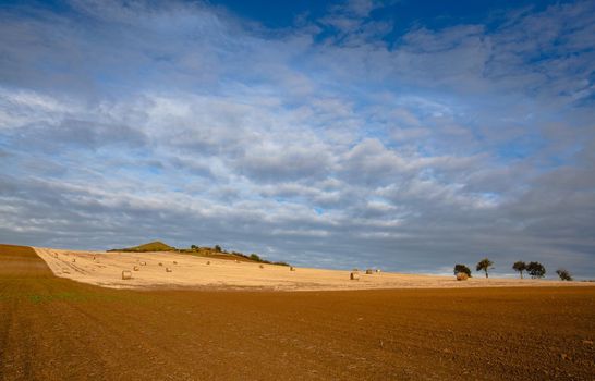 Straw bales on a stubble in Central Bohemian Uplands, Czech Republic. Field landscape bales of straw on a farm field