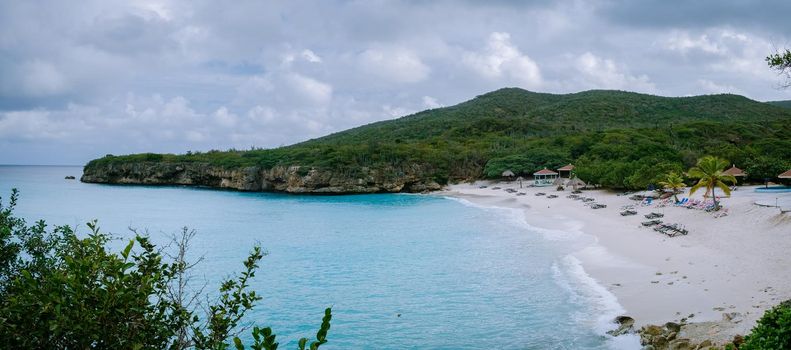 Grote knip beach Curacao, Island beach of Curacao in the Caribbean men and woman on vacation visit the beach. couple mid age men and woman on the beach Playa Knip