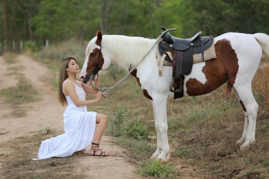 Women on skirt dress Riding Horses On field landscape Against Sky During Sunset