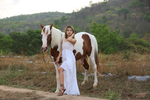 Women on skirt dress Riding Horses On field landscape Against Sky During Sunset