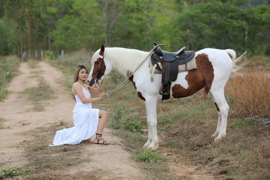 Women on skirt dress Riding Horses On field landscape Against Sky During Sunset