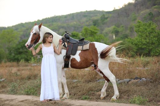 Women on skirt dress Riding Horses On field landscape Against Sky During Sunset