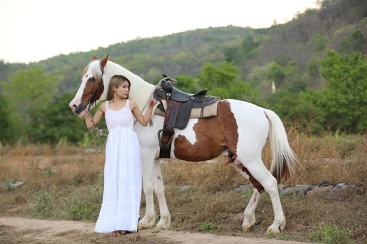 Women on skirt dress Riding Horses On field landscape Against Sky During Sunset