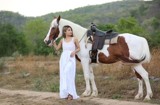 Women on skirt dress Riding Horses On field landscape Against Sky During Sunset
