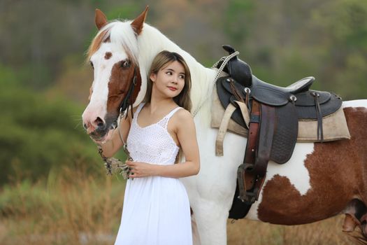 Women on skirt dress Riding Horses On field landscape Against Sky During Sunset