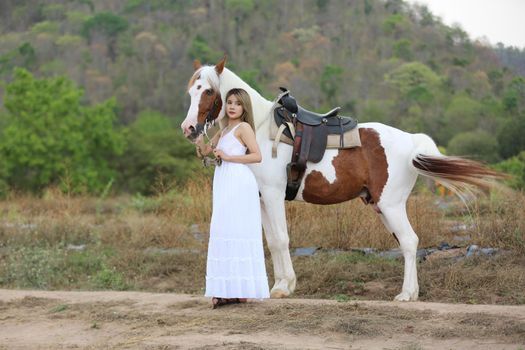 Women on skirt dress Riding Horses On field landscape Against Sky During Sunset