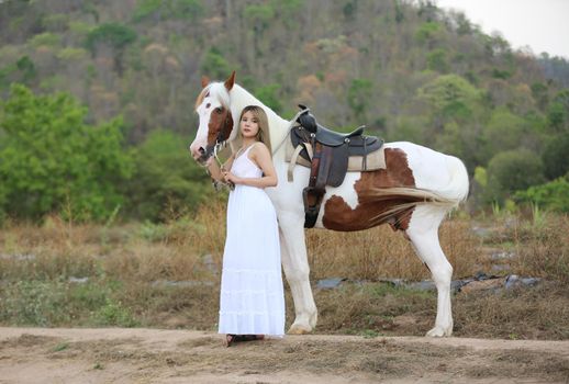 Women on skirt dress Riding Horses On field landscape Against Sky During Sunset