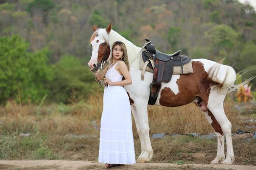 Women on skirt dress Riding Horses On field landscape Against Sky During Sunset