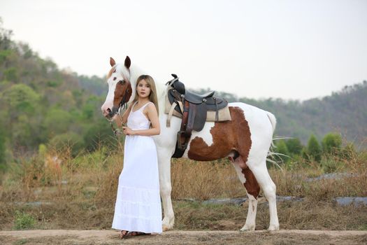 Women on skirt dress Riding Horses On field landscape Against Sky During Sunset