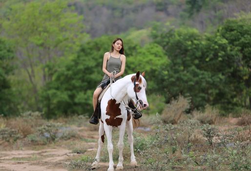 Women on skirt dress Riding Horses On field landscape Against Sky During Sunset