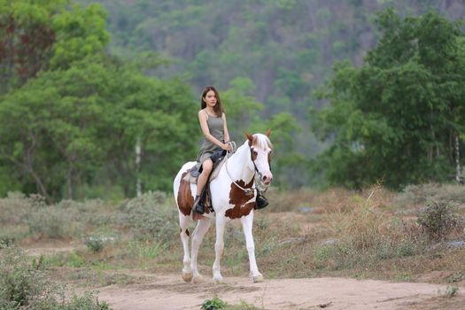 Women on skirt dress Riding Horses On field landscape Against Sky During Sunset