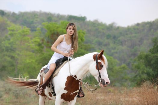 Women on skirt dress Riding Horses On field landscape Against Sky During Sunset