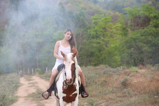 Women on skirt dress Riding Horses On field landscape Against Sky During Sunset