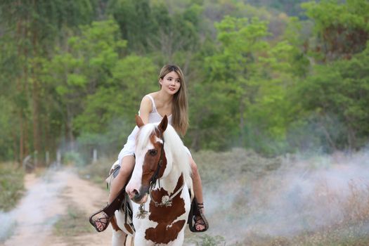 Women on skirt dress Riding Horses On field landscape Against Sky During Sunset