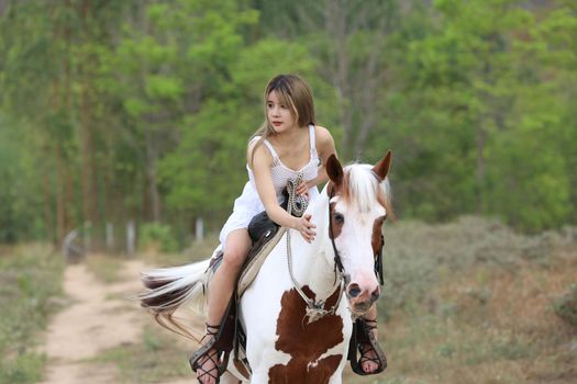 Women on skirt dress Riding Horses On field landscape Against Sky During Sunset