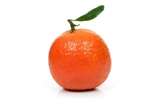 Single perfect orange or tangerine fresh fruit with leaf on a white background in close-up