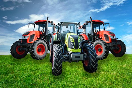 Group of new and modern agricultural generic tractors on a green meadow in sunny day(mixed)