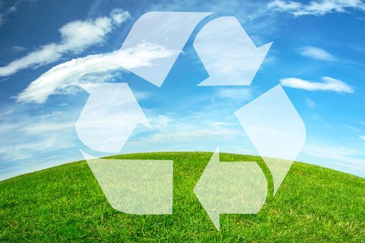 Composite image of an environmental conservation - recycle sign on a green meadow and blue sky earth horizon