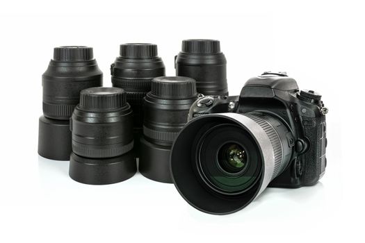 Collection of professional and modern lenses and DSLR camera isolated on a white background in close-up