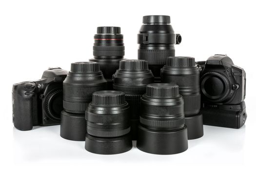 Large collection of professional and modern lenses and DSLR cameras isolated on a white background.