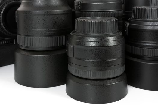 Collection of professional and modern lenses and DSLR camera in close-up.