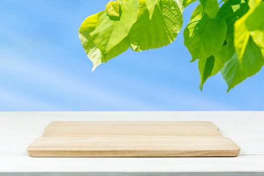 Mock-up of organic outdoor cooking or product presentation- empty wooden plank on the table (mixed)