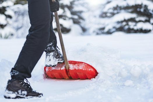 Public service worker or citizen shoveling snow during heavy winter weather