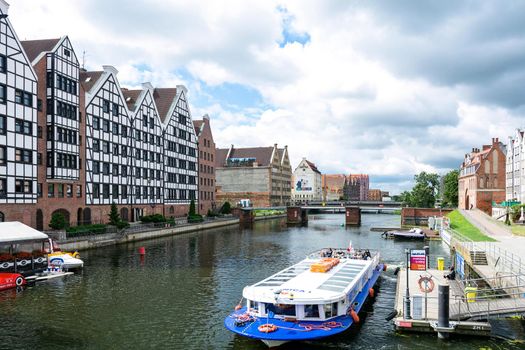 Gdansk, Poland - June 26, 2018: Tourist cruise ship on Motlawa river in historical Old Town of Gdansk City