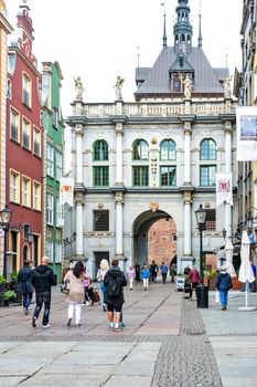 Gdansk, Poland - June 26, 2018: Tourists visiting famous Golden Gate in old town of Gdansk.