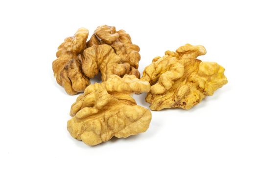 Dry and shelled walnuts isolated on a white background