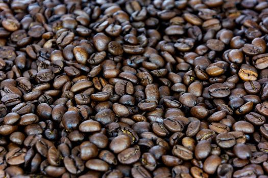 Premium coffee background - many roasted brown beans in close-up as a texture (high details).