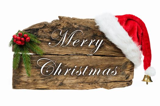 Christmas decoration - old wooden board sign with Santa hat and spruce twig on white background