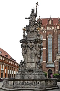 Wroclaw, Poland - July 20, 2017:Statue of St. John of Nepomuk created by Jan Jiri Urbansky in 1732 on the square of Collegiate church of the Holy cross and St Bartholomew on the Cathedral Island  ( Ostrow Tumski) in Wroclaw.