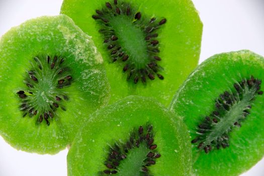 Bright green candied kiwi fruit with seeds close-up. Dried fruits. Candied kiwi.