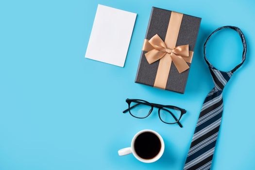 Design concept top view of Father's day gift idea with greeting white blank mockup on blue table background.