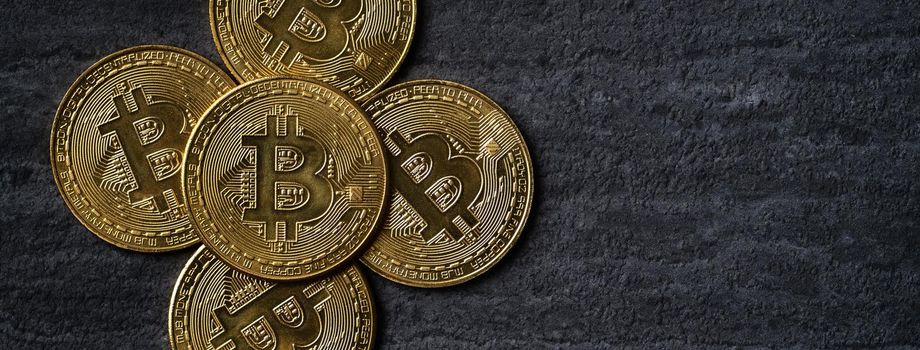 Top view business concept of bitcoin cryptocurrency money on dark black slate table background.