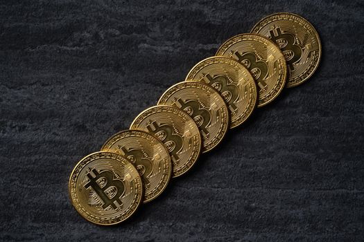 Top view business concept of bitcoin cryptocurrency money on dark black slate table background.