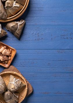 Zongzi rice dumpling with ingredients top view for Chinese traditional Dragon Boat Festival (Duanwu Festival) over blue wooden table background.