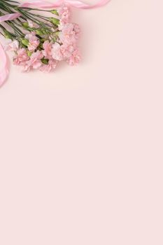 Design concept of Mother's day holiday greeting design with carnation bouquet on pastel pink table background