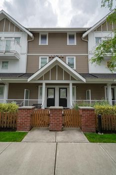 Entrance doors of residential townhouses under the porch. Attached residential townhomes entrance