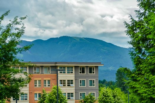 Residential building on mountain and cloudy sky background