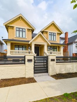 Newly renovated luxury residential house for sale. Big family house for with concrete pathway and metal  fence in front