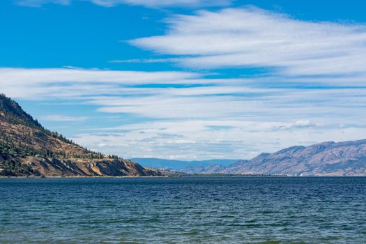 Panoramic view of mountains and Okanagan lake on summer evening