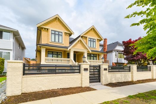 Newly renovated luxury residential house for sale. Big family house for with concrete pathway and metal  fence in front